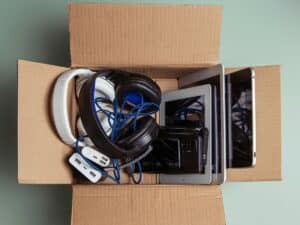 Box full of assorted electronic accessories and cables
