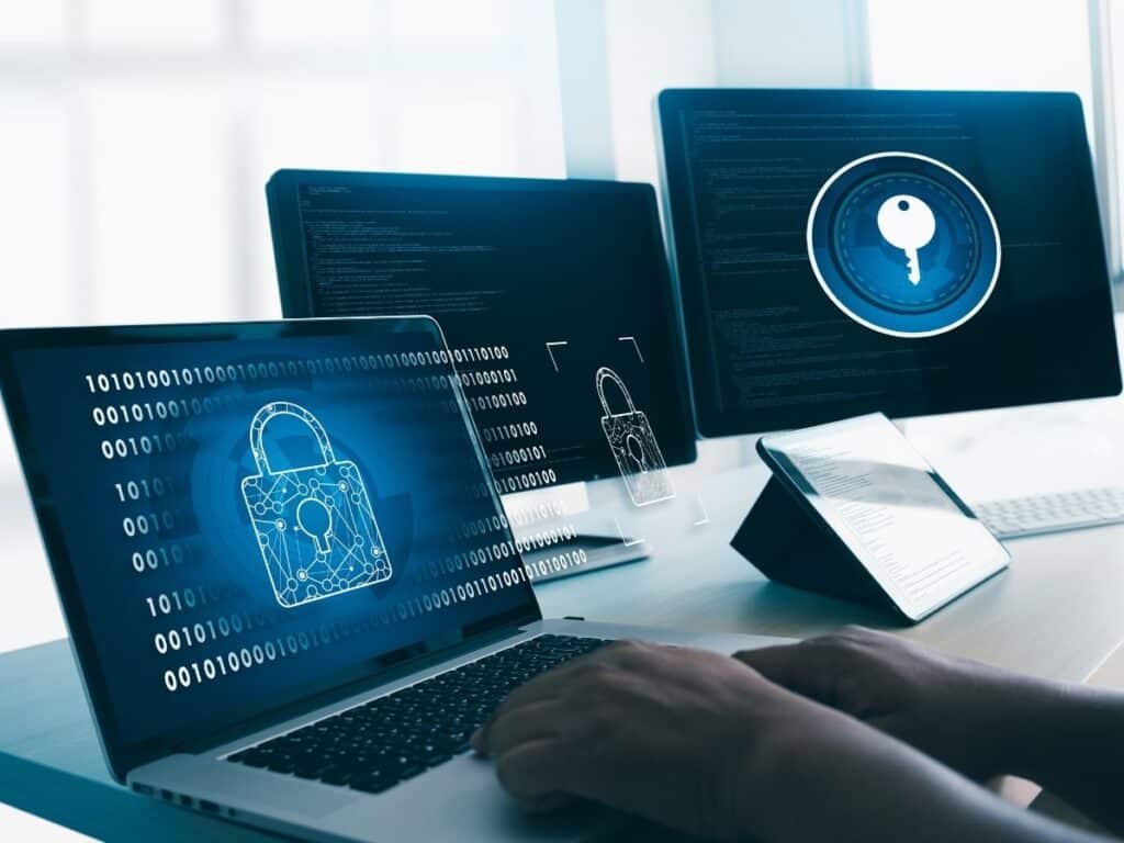 User at laptop with digital padlock and cybersecurity interface