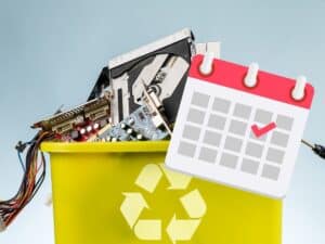 E-waste spilling out of trash bin with calendar and gadgets
