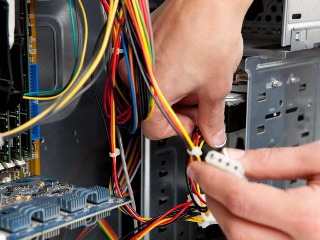 Hands assembling or disassembling computer hardware